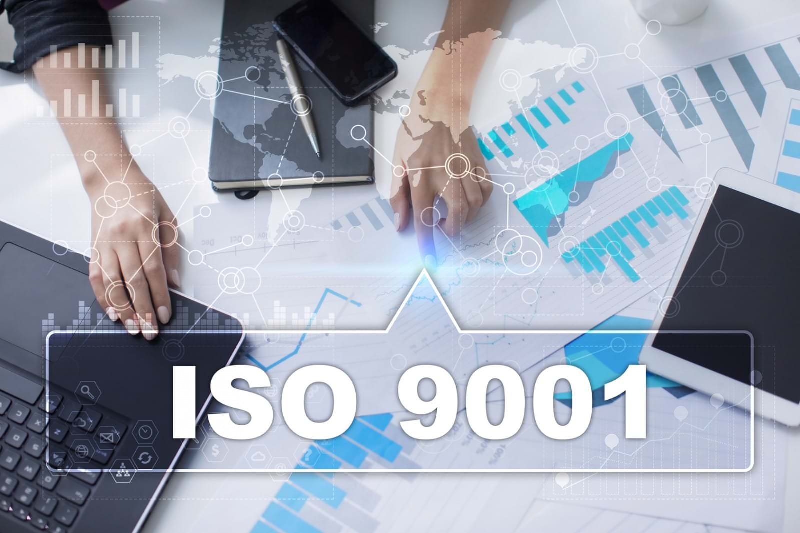 Ruland Woman is working with documents, tablet pc and notebook and selecting iso 9001. Photo ISO 9001 works